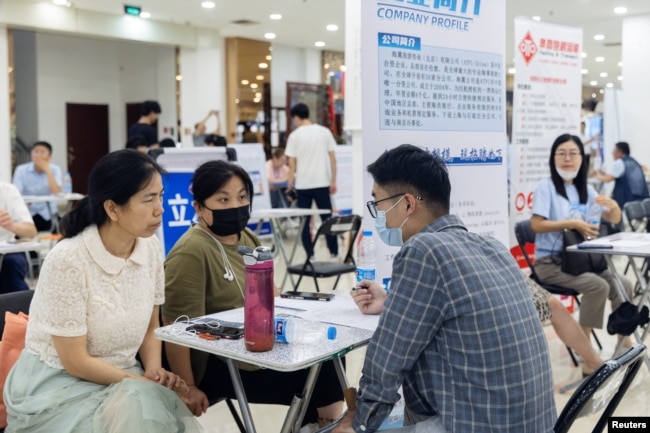 People attend a job fair in a mall in Beijing, China, June 30, 2023.