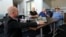 Tracy Hall of Mynd Immersive, left, watches as Karen Audet, 82, right, reacts while wearing a virtual reality headset at John Knox Village, Jan. 31, 2024, in Pompano Beach, Fla. 