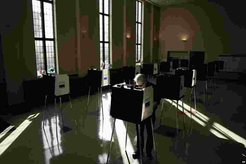 A person votes during Election Day, at Knox Presbyterian Church in Cincinnati. Polls are open in a few states for off-year elections that could give hints of voter sentiment ahead of next year's critical presidential contest.