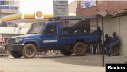 FILE — Screenshot from a Reuters video report that shows Guinean police outdoors in the capital, Conakry, during a nationwide strike, on February 26, 2024