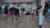 9일 러시아 블라디보스토크 공항에서 북한 행 항공기 입국을 준비 중인 단체 관광객들.