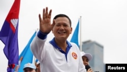 FILE - Hun Manet, son of Cambodia's Prime Minister Hun Sen, waves to people during the final Cambodian People's Party election campaign for the upcoming general election in Phnom Penh, Cambodia, July 21, 2023. 