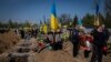 Undertakers lower the coffin of Ukrainian serviceman Andrii Vorobiov at the Kryvyi Rih cemetery in eastern Ukraine, April 24, 2023. 