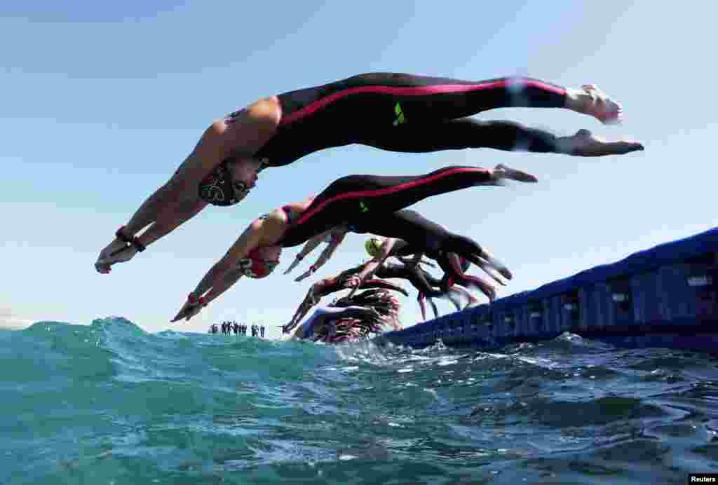 Swimmers compete during the women&#39;s 5km open water final at the World Aquatics Championships in Doha, Qatar.