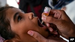 A health worker administers a polio vaccine to a child at a hospital in Deir al-Balah, central Gaza Strip, Sept. 1, 2024. 