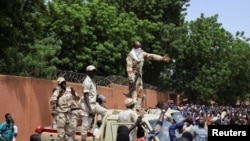 FILE - Nigerian security forces prepare to disperse pro-junta demonstrators gathered outside the French embassy, in Niamey, the capital city of Niger, July 30, 2023.