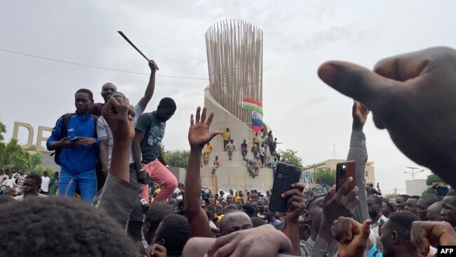 Supporters of the Nigerian security forces that took control of the country gather during a demonstration outside the national assembly in Niamey on July 27, 2023.
