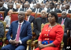 FILE - Haiti's President Jovenel Moise sits with his wife, Martine, during his swearing-in ceremony at Parliament in Port-au-Prince, Haiti, Feb. 7, 2017.