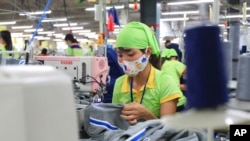 资料照片：2017年10月24日，一名工人在越南南定省的一家运动衣工厂缝制服装。（美联社照片）
