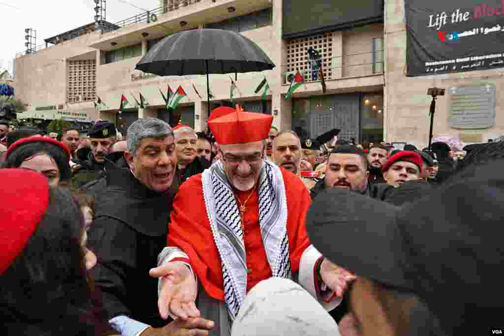 El Patriarca Latino de Jerusalén, Pierbattista Pizzaballa, saluda al llegar a Belén, en su habitual peregrinación a la Basílica de la Natividad, lugar donde nació Jesús. El representante del Papa en Tierra Santa dijo a periodistas que estas &ldquo;son unas Navidades muy tristes, no hay ambiente de fiesta, porque estamos en guerra&rdquo;. Pierbattista llegó a una Belén despojada de todo ambiente festivo o navideño, mientras se recuerdan a las víctimas de la guerra en Gaza.