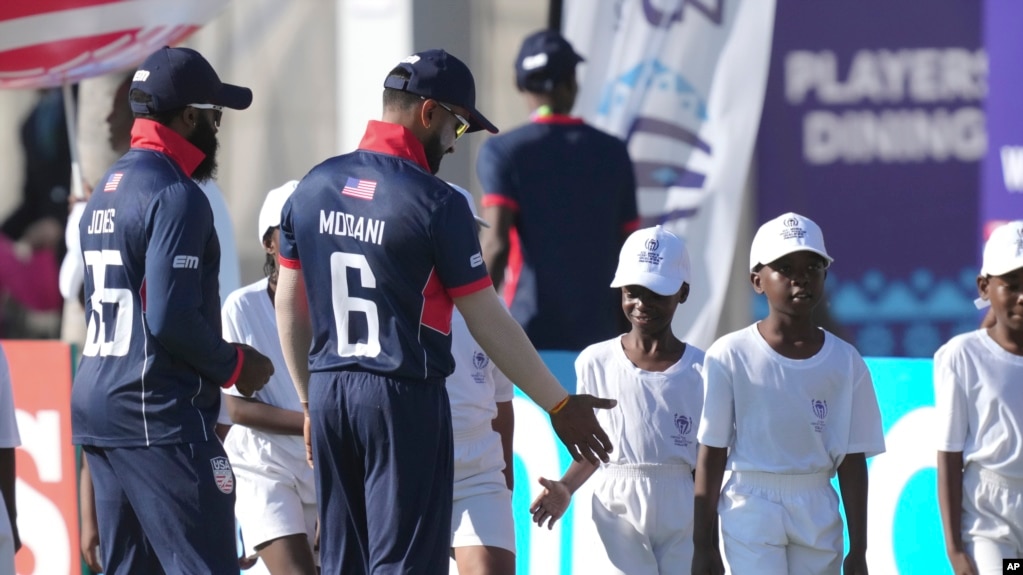 Members of the U.S. cricket team greet boys at Takashinga Cricket. Club in Highfields, June, 18, 2023. Takashinga Cricket Club, set in one of the country's oldest Black townships, hosted an international game for the first time. 