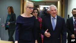 Yulia Navalnaya, wife of the late Russian opposition leader Alexey Navalny, left, walks with European Union foreign policy chief Josep Borrell during a meeting of EU foreign ministers in Brussels, Feb. 19, 2024.