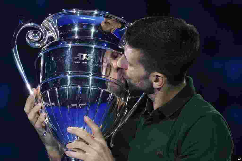 Serbia&#39;s Novak Djokovic kisses the trophy as ATP world best player at the ATP World Tour Finals, at the Pala Alpitour, in Turin, Italy.