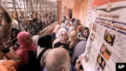 Egyptian voters crowd to cast their votes for the presidential elections at a polling station, in Cairo, Dec. 10, 2023. Egyptians began voting Sunday in an election in which President Abdel Fattah el-Sissi is certain to win another term.