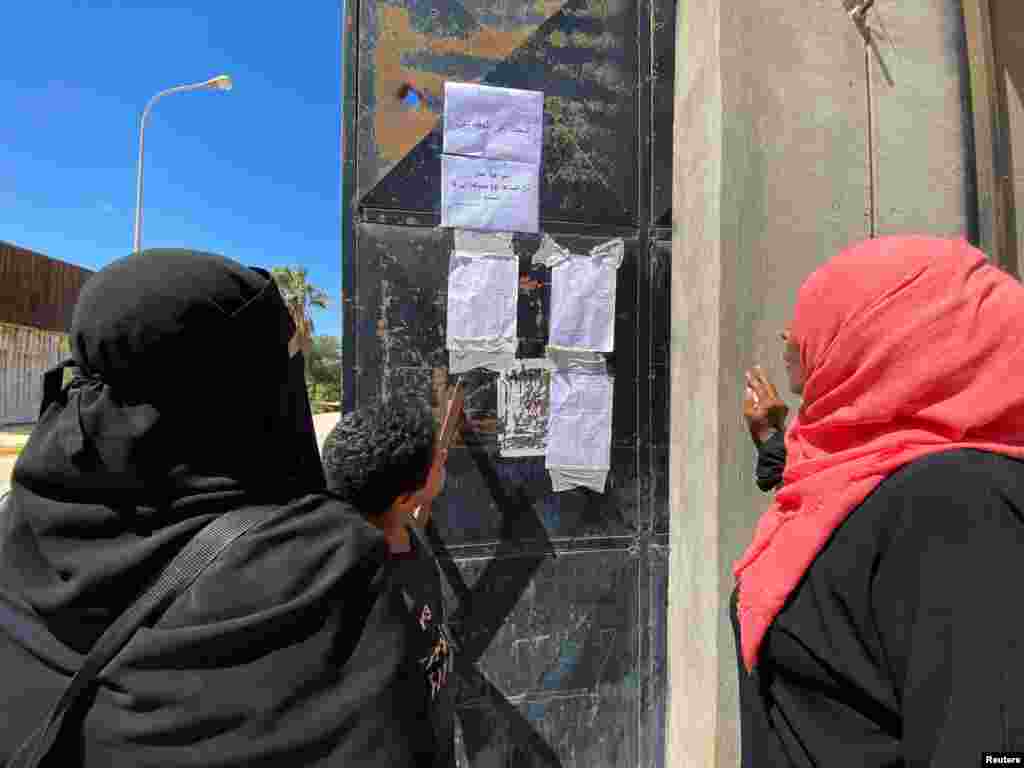 People look at the list of missing people, in the aftermath of the floods in Derna, Sept. 14, 2023.
