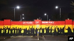 A mural on the peace gates at Lanark Way celebrates the Good Friday Agreement, in west Belfast, April 5, 2023. 