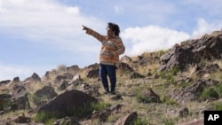 FILE - Michon Eben, historic preservation officer for the Reno-Sparks Indian Colony, looks on near a massacre site at Sentinel Rock on April 25, 2023, outside of Orovada, Nev.