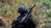 FILE - A soldier from the Karen National Liberation Army (KNLA) carries an RPG launcher at a Myanmar military base on the outskirts of Myawaddy, the Thailand-Myanmar border town under the control of a coalition of rebel forces, in Myanmar, April 15, 2024.