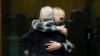 Ethan Elder, left, father of Finnegan Lee Elder, hugs his son at the end of a hearing for the appeals trial in which Finnegan is facing murder charges for killing Italian Carabinieri paramilitary police officer Mario Cerciello Rega, in Rome, July 3, 2024.