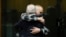 Ethan Elder, left, father of Finnegan Lee Elder, hugs his son at the end of a hearing for the appeals trial in which Finnegan is facing murder charges for killing Italian Carabinieri paramilitary police officer Mario Cerciello Rega, in Rome, July 3, 2024.