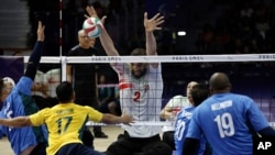 Iran's Morteza Mehrzadselakjani blocks the ball during the preliminary sitting volleyball match against Brazil during the Paralympic Games in Paris, Sept. 1, 2024.