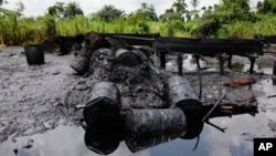 FILE- An abandoned illegal oil refinery is seen after it was raided by the Nigerian navy at Bayelsa, Nigeria, May 18, 2013. Nigerian officials have said the country loses $700 million every month as a result of oil thefts.