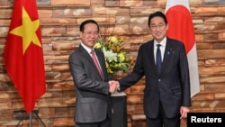 FILE - Vietnam's President Vo Van Thuong, left, is welcomed by Japan's Prime Minister Fumio Kishida during his visit to Japan, at the prime minister's official residence in Tokyo, Nov. 27, 2023.