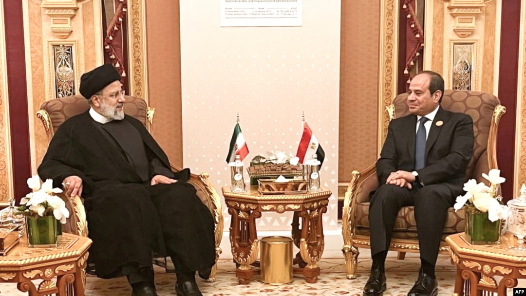 A handout picture provided by the Iranian presidency on Nov. 11, 2023, shows Iran's President Ebrahim Raisi, left, meeting with Egypt's President Abdel Fatah al-Sisi during the emergency meeting of the Arab League and the Organization of Islamic Cooperation (OIC), in Riyadh.