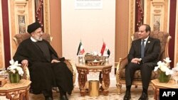 A handout picture provided by the Iranian presidency on Nov. 11, 2023, shows Iran's President Ebrahim Raisi, left, meeting with Egypt's President Abdel Fatah al-Sisi during the emergency meeting of the Arab League and the Organization of Islamic Cooperation (OIC), in Riyadh.