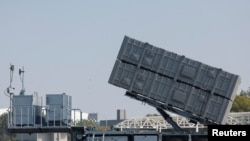 Members of Taiwan's armed forces are pictured next to a mobile missile launcher during a drill part of a demonstration for the media, at a military base in Kaohsiung, Jan. 31, 2024.