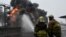 Ukrainian emergency personnel douse water to extinguish flames after a fire erupted at the site of a drone attack in Kharkiv, Feb. 10, 2024. Seven people, including three children, were killed in a Russian drone attack on the city of Kharkiv. 