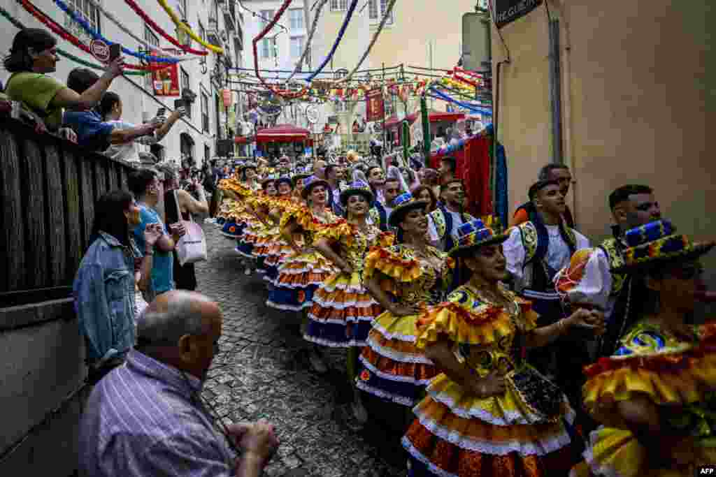 Revelers from the Alfama neighborhood parade in the streets before attending the Santo Antonio de Lisboa&#39;s Parade on Avenida da Liberdade, in Lisbon, Portugal, June 12, 2023.