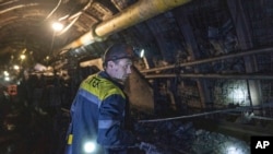 A miner stands in the tunnel at the coal mine in Dnipropetrovsk region, Ukraine, April 7, 2023.