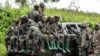 FILE - M23 rebels load a pickup truck in Kibumba, in the eastern of Democratic Republic of Congo, Dec. 23, 2022. 