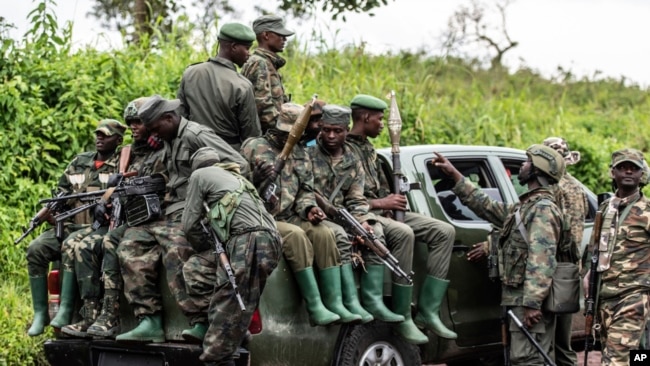 FILE - M23 rebels load a pickup truck in Kibumba, in the eastern of Democratic Republic of Congo, Dec. 23, 2022.