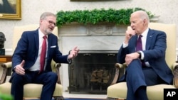 Prime Minister Petr Fiala of the Czech Republic speaks with U.S. President Joe Biden during a meeting in the Oval Office at the White House, April 15, 2024.