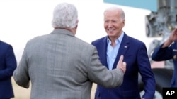 President Joe Biden greets former Rep. Bob Brady as he arrives at Philadelphia International Airport, March 8, 2024. The president and first lady Jill Biden were headed to Delaware County, Pa., for a campaign event.