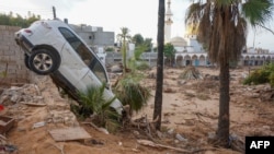 Vehicles are buried in mud and rubble in the aftermath of a devastating flood in eastern Libya's city of Derna, Sept. 16, 2023. 