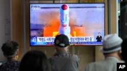 A TV screen shows a file image of North Korea's rocket launch during a news program at the Seoul Railway Station in Seoul, South Korea, Wednesday, May 31, 2023. (AP Photo/Ahn Young-joon)