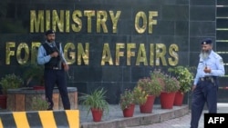 FILE - Pakistani policemen stand guard outside Pakistan's Foreign Ministry building in Islamabad, Sept. 2, 2019. 