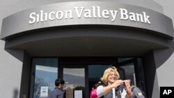 Seorang nasabah berswafoto di luar kantor pusat Silicon Valley Bank di Santa Clara, California, 13 Maret 2023. (Foto: Benjamin Fanjoy/AP Photo)