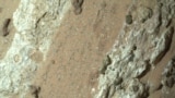 This handout image obtained on July 26, 2024, courtesy of NASA/JPL-Caltech/MSSS shows a reddish rock nicknamed "Cheyava Falls" in Mars' Jezero Crater on July 18, 2024, in an image captured by NASA's Perseverance rover. 