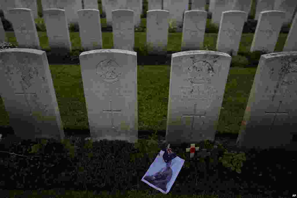 A photo and flag are left at the grave of World War I Australian soldier Alan Humphrey Scott during an ANZAC Day dawn service at Buttes New British Cemetery in Zonnebeke, Belgium.&nbsp;ANZAC Day is a national day of remembrance in Australia and New Zealand for those who served in all wars.