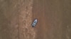 FILE - A boat is seen stranded on the dry riverbed of the Pahang river in Chenor, Malaysia's Pahang state, Aug. 10, 2023.