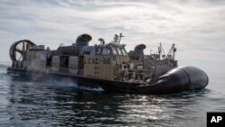 In this image provided by the U.S. Navy, sailors operate landing craft air cushions (LCAC) during recovery efforts of debris from a Chinese high altitude balloon in the Atlantic Ocean on Feb. 8, 2023. (Eric Moser/U.S. Navy via AP)