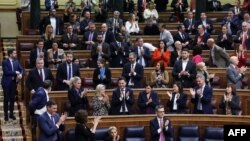 Members of the Socialist parliamentary group applaud at the end of a plenary session of Spain's legislature during which an amnesty bill that exonerates figures linked to Catalonia's 2017 failed secession bid was approved, in Madrid, March 14, 2024.