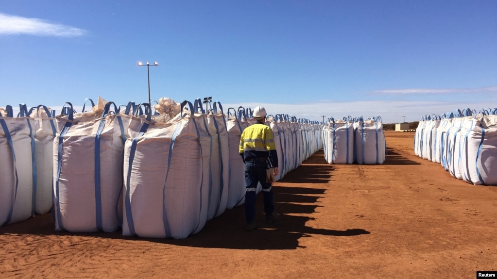 FILE - A Lynas Corp worker walks past sacks of rare earth concentrate waiting to be shipped to Malaysia, at Mount Weld, northeast of Perth, Australia August 23, 2019. (REUTERS/Melanie Burton/File Photo)