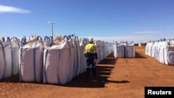 FILE - A Lynas Corp worker walks past sacks of rare earth concentrate waiting to be shipped to Malaysia, at Mount Weld, northeast of Perth, Australia August 23, 2019. (REUTERS/Melanie Burton/File Photo)