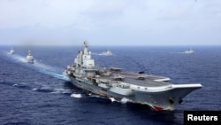 China's aircraft carrier Liaoning takes part in a military drill of Chinese People's Liberation Army (PLA) Navy in the western Pacific Ocean, April 18, 2018. Picture taken April 18, 2018.