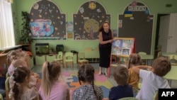 A teacher leads a class about mine safety in a kindergarten in Kryvyi Rih, Ukraine, Sept. 14, 2023. Teachers, along with civil servants and pensioners, could see delayed pay if Western aid to the country is not approved soon, officials say. 